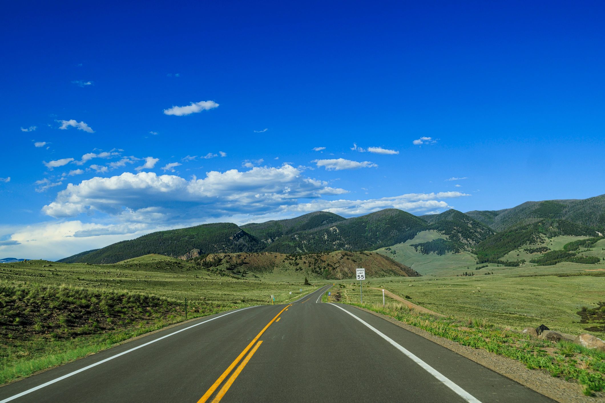 Open road leading toward scenic hills